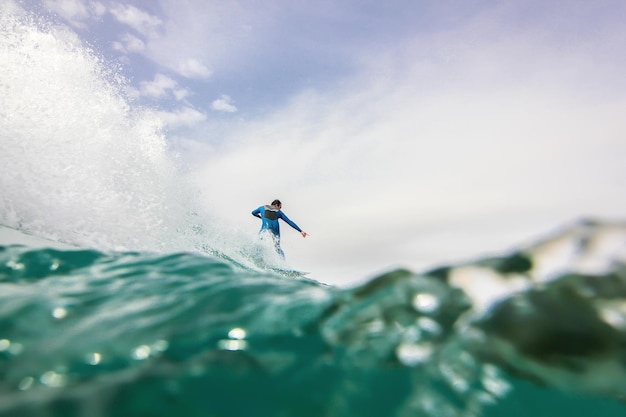 man surfing in sea against sky