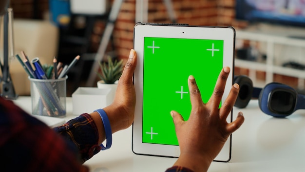 Manager femminile che utilizza il display a schermo verde su tablet moderno, analizzando il modello di mockup isolato sul gadget. Lavorare con copyspace chiave cromatica vuota su un dispositivo wireless portatile. Avvicinamento.