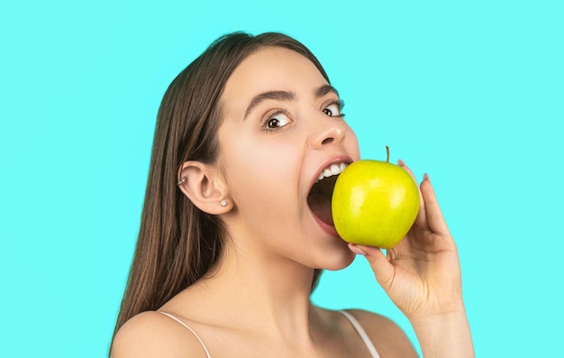 Mangiare una mela Ritratto di una donna che mangia una mela verde Una donna sorridente con denti sani