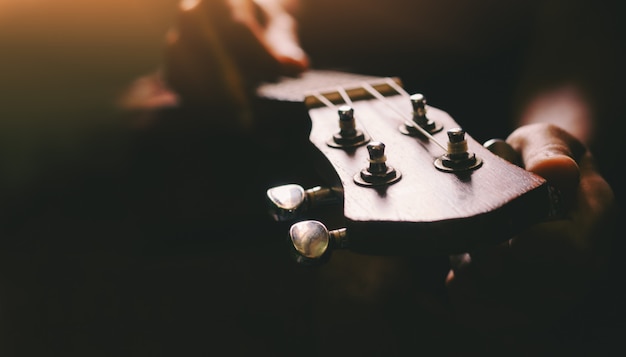 Mani che giocano la chitarra acustica delle ukulele. Spettacolo di abilità musicali