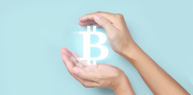 Mani che mostrano l'icona bitcoin come denaro virtuale su digital