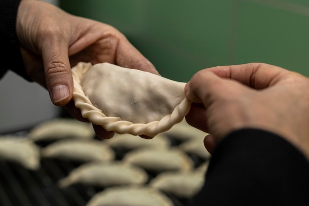 Mani che preparano empanadas argentine ripiene di soia Cibo vegano e vegetariano