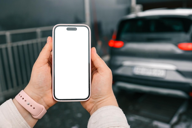 Mani con uno schermo di telefono vuoto sullo sfondo di un lavandino auto