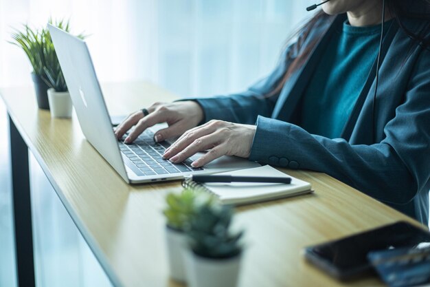 Mani della donna che digitano sulla tastiera del computer donna di affari del primo piano che utilizza il computer portatile a casa