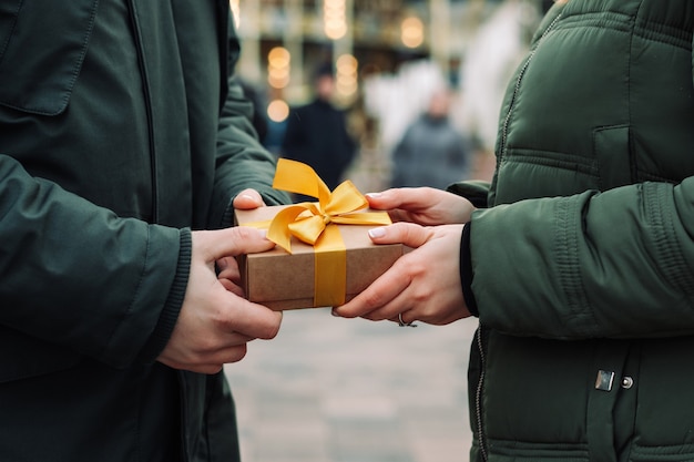 Mani di una coppia con un regalo presente