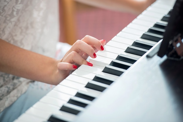 Mani femminili che suonano un pianoforte