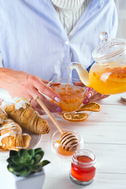 Mani femminili che tengono tazza di tè calda