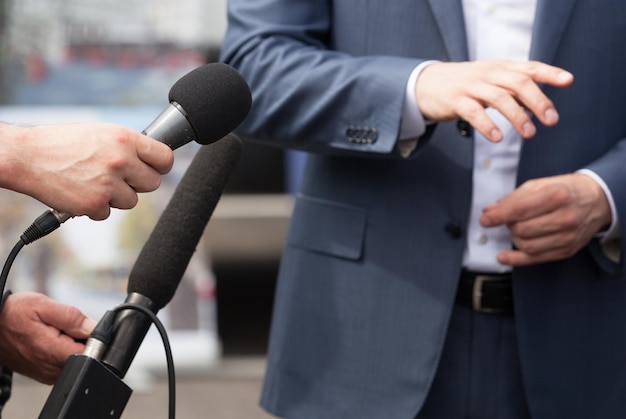 Mani tagliate di giornalisti che intervistano un uomo d'affari