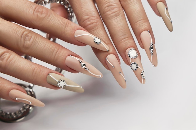 Manicure nude con strass su unghie lunghe