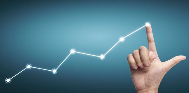 Mano che tocca un grafico dell'indicatore finanziario e del grafico di analisi dell'economia di mercato contabile