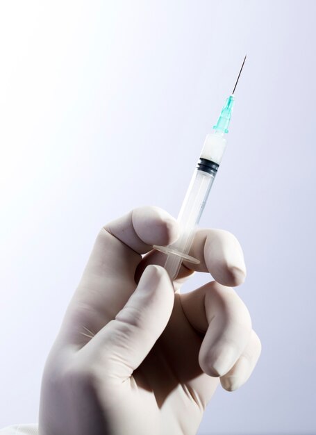 mano del medico con la siringa per l'iniezione del vaccino contro il coronavirus.
