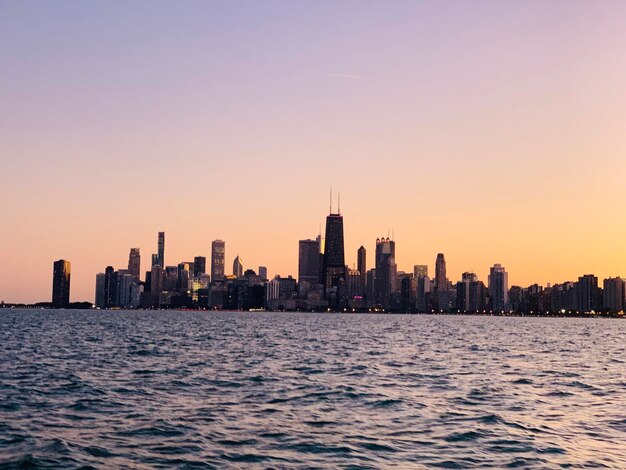 Mare e edifici contro un cielo limpido al tramonto