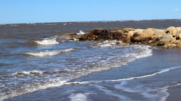 Mare e rocce, sassi, vento, onde. Spiagge del Mediterraneo, Denia. Spagna Cielo blu, resort e spiaggia.