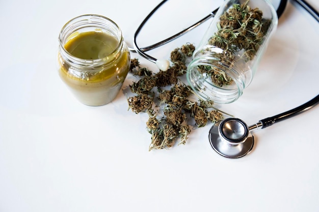 Marijuana medica e vasetto di vetro olio ya Stetoscopio al concetto di medicina