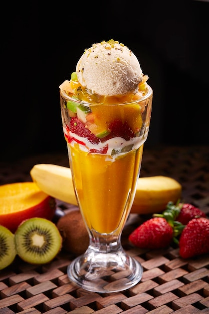 Marmaris Cocktail con gelato e banana alla fragola e mango servito in vetro isolato sul tavolo vista laterale del cibo mediorientale