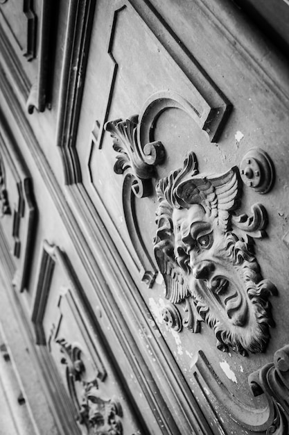 Maschera gotica su una vecchia porta di legno a Milano - Italia