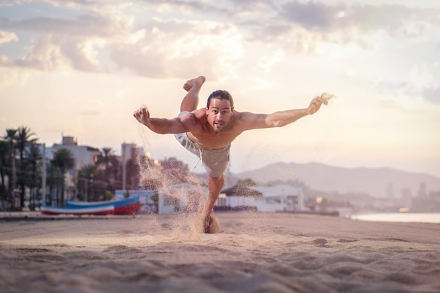 Maschio caucasico atletico che si allena sulla spiaggia al mattino presto - concetto di stile di vita sano