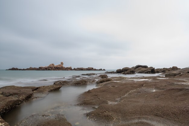 Mattinata nuvolosa, acqua di mare, scogliere e isole