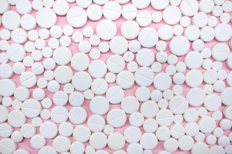 Medical pills on pink wall wallpaper