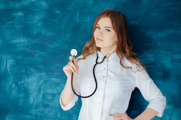 Medico della giovane donna nelle camice e nella mascherina medica. La medicina