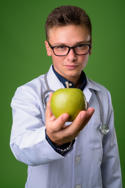 Medico giovane uomo bello su sfondo verde