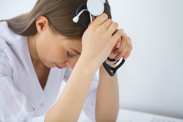 Medico. Infermiera femminile triste o piangente all'ufficio dell'ospedale