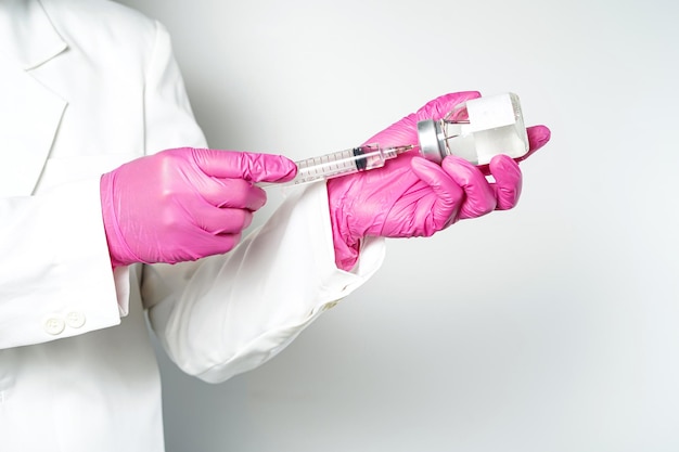 medico o scienziato con una siringa con ampolle bottiglia di vaccino per iniezione