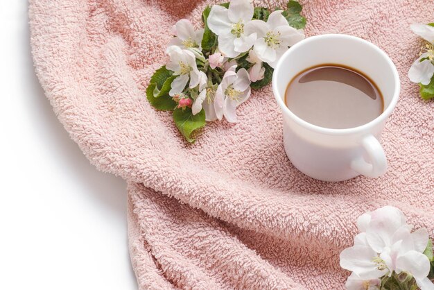 Mela che fiorisce con una tazza di caffè sullo spazio piatto della copia dell'asciugamano di pelliccia