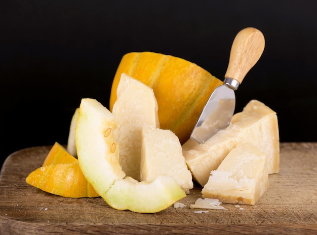 Melone con formaggio parmigiano su tavola di legno