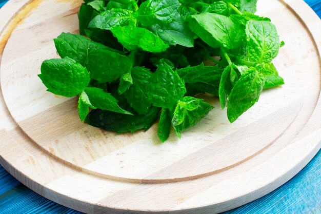 Menta fresca sullo spazio della copia della tavola di legno. Messa a fuoco selettiva