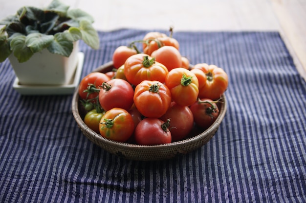 Merce nel carrello dei pomodori rossi crudi freschi sulla tabella