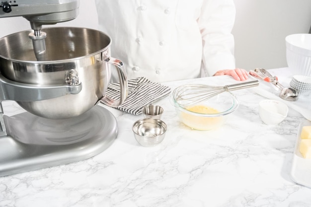 Mescolare gli ingredienti in una planetaria da cucina per cuocere i cupcakes alla vaniglia.