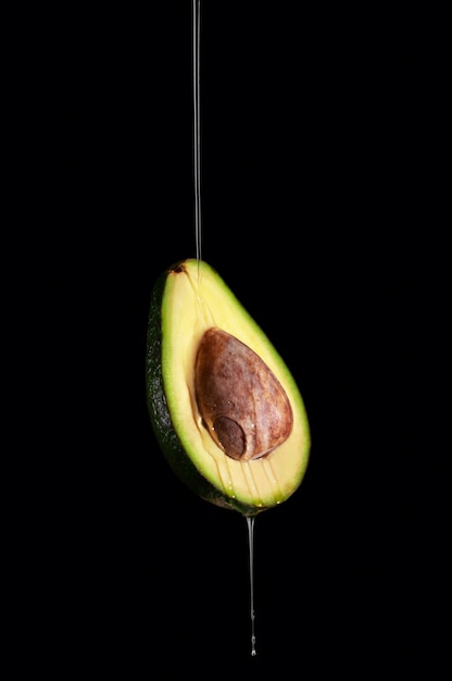 Mezzo avocado maturo su sfondo scuro