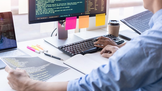 midsection of computer programmer working on table