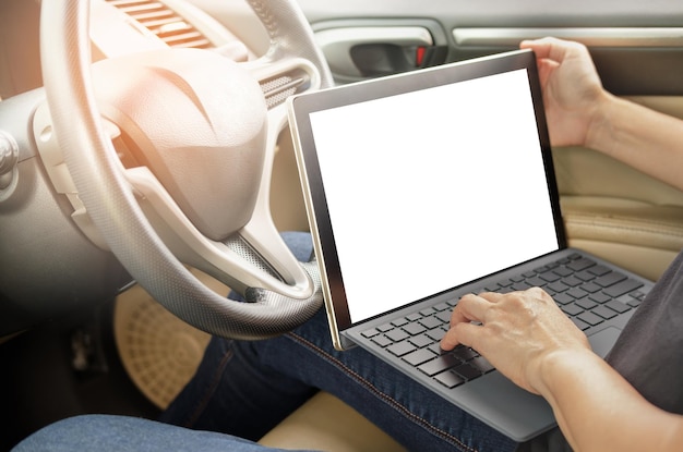 Midsection of man using laptop in car