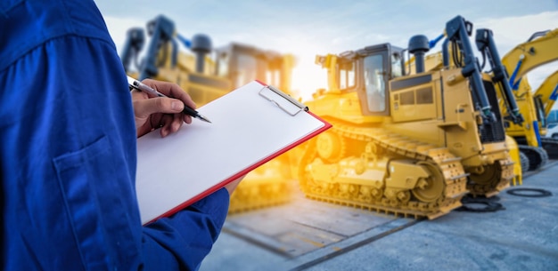 Midsection of man writing on paper at construction site