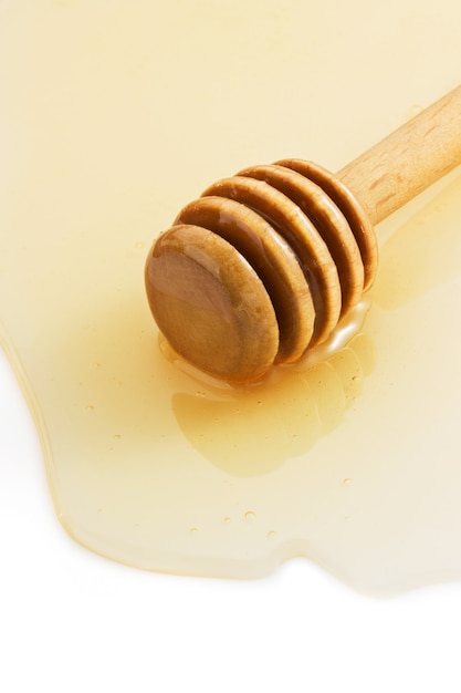 Miele e bastone isolati su bianco