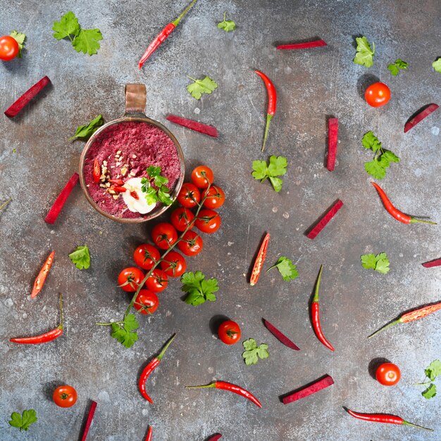 Minestra vegetariana della bietola rossa in tazza di rame su oscurità. Squared.