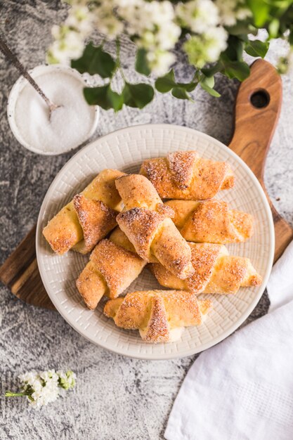 Mini croissant fatti in casa della ricotta su un fondo concreto grigio. colazione con cornetti