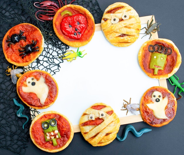 Mini pizza cibo di Halloween con olive al formaggio e ketchup Cibo pazzo divertente per bambini