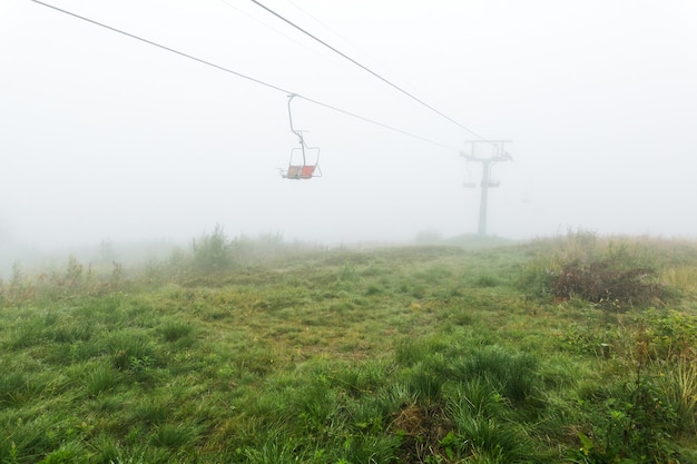 Mistica seggiovia vuota nella nebbia