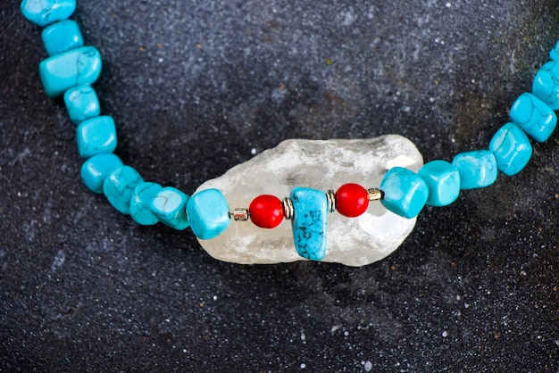 Mix di collane e bracciali colorati, perline e collana di pietre, gioielli su sfondo blu