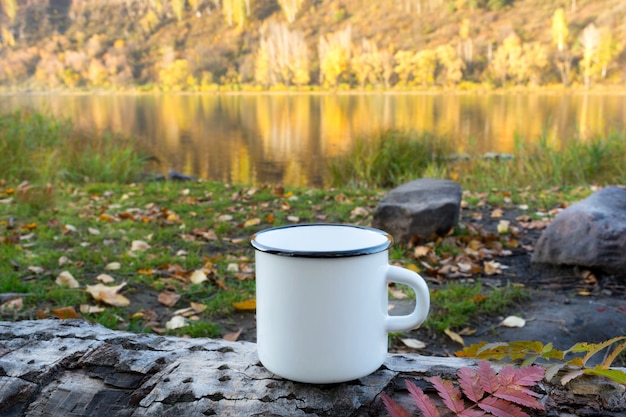 Mockup di tazza in smalto bianco con foglia rossa