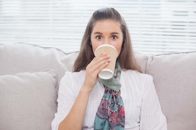 Modello grazioso sorridente che beve caffè