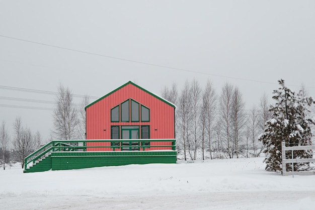 Moderna casa in legno in stile scandinavo con giorno invernale di colore diverso nel villaggio