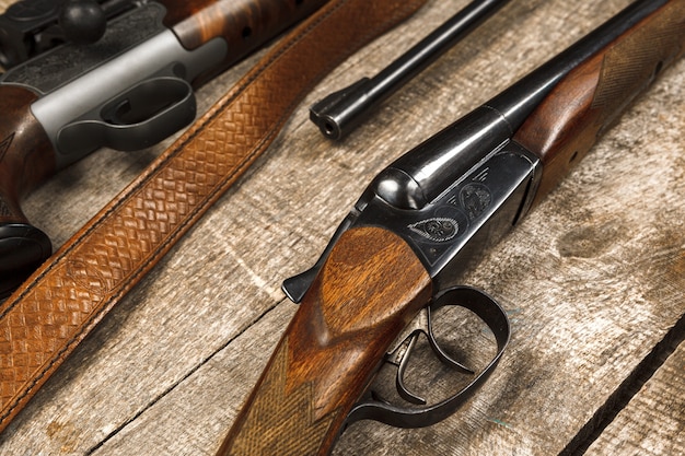 Molti fucili da caccia su una superficie di legno stagionata