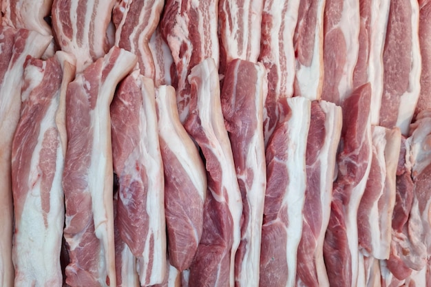 Molti pezzi di carne di maiale rossa fresca cibo sfondo