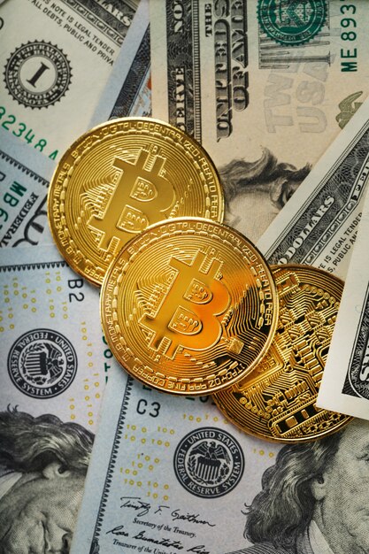 Monete d'oro Bitcoin sulle banconote in dollari USA