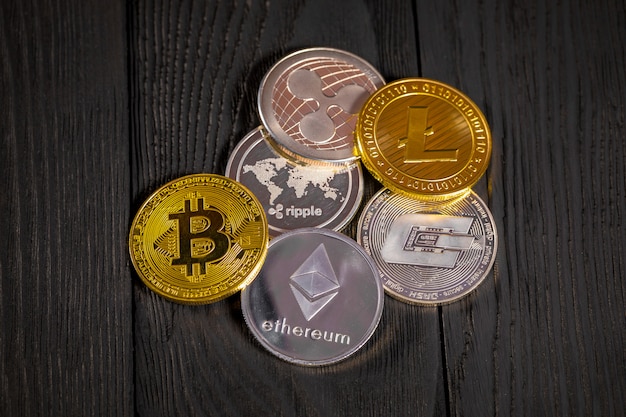 Monete d'oro con bitcoin, su legno.