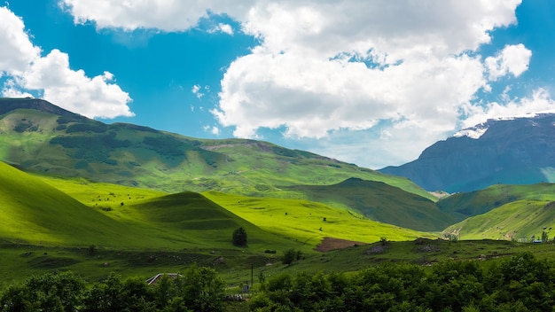 Montagne verdi e paesaggio di nuvole blu